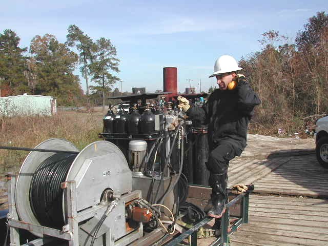 Early AirShock water well rehabilitation job with hose reel and gas cylinders in the field