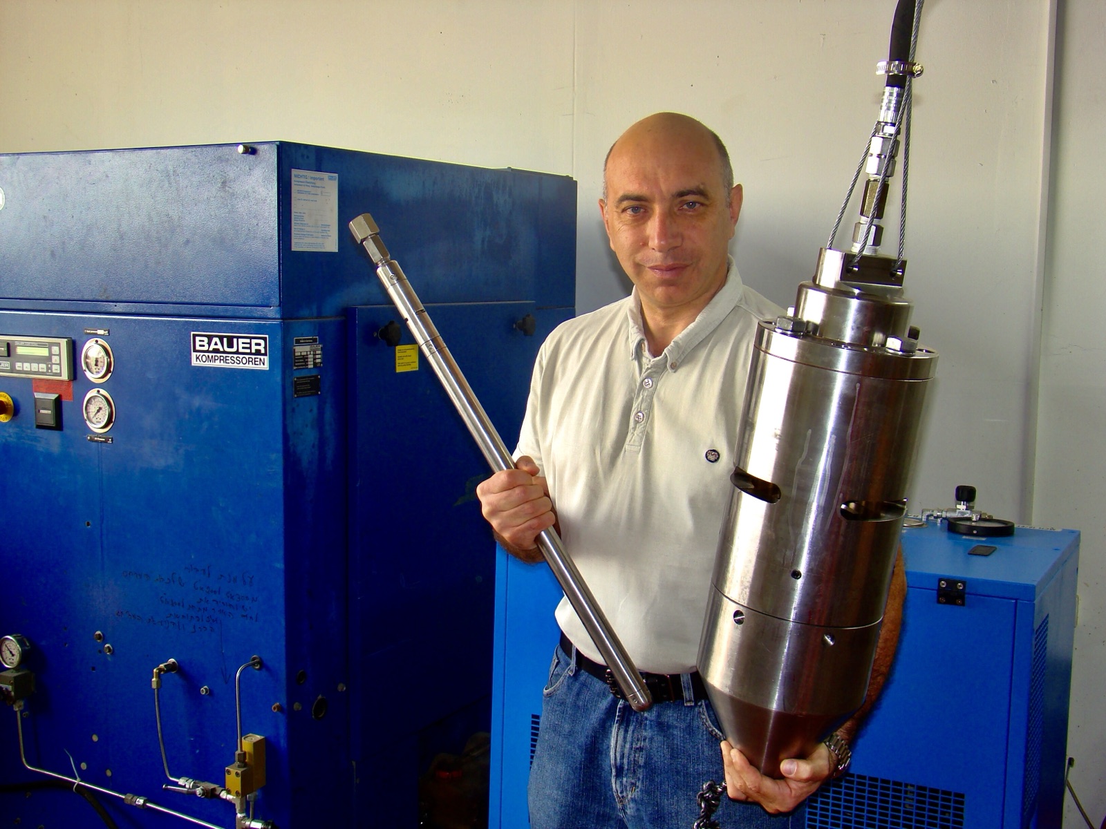 Dr. Gennady Carmi holding the smallest and largest AirShock AIG impulse generators